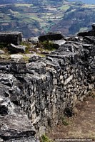 Solid rock walls high on the hill overlooking the countryside, Kuelap ruins, Chachapoyas. Peru, South America.