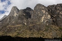 Huge rock faces tower above in the mountains around Paron Lake in Caraz. Peru, South America.