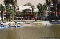 Restaurant with tables outside beside the water in Huacachina. Peru, South America.