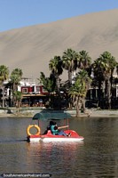 Pedal boat on the lagoon, fun with nice surroundings in Huacachina. Peru, South America.