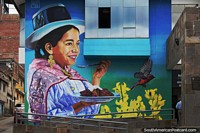 Larger version of Indigenous girl eats a plate of food, large mural at the central cultural building in Ayacucho.