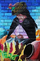 Lady with flowers and a large urn, colorful mural in Ayacucho. Peru, South America.