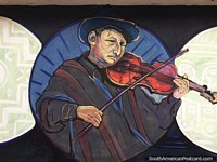 Man in a shawl playing violin, street art in Ayacucho.