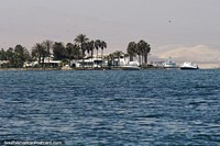 Luxury properties and boats on the coast in Paracas, deep blue seas. Peru, South America.