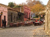 Restaurant with tables on the cobblestones, Colonia historical area. Uruguay, South America.