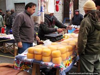 Round blocks of cheese at La Feria Tristan Narvaja markets in Montevideo. Uruguay, South America.