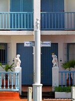 3 white mini statues outside a house near the lighthouse in Punta del Este.