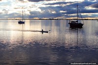 Rowers practice on the Uruguay River in Fray Bentos. Uruguay, South America.
