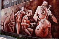 Cello, guitar, violin, saxophone and trumpet, musicians play, street art in Mercedes. Uruguay, South America.