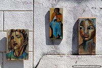 3 pinturas de mujeres, cada una pintada sobre madera, exhibidas en la calle en Colonia del Sacramento. Uruguay, Sudamerica.