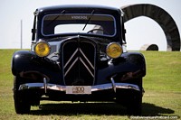 Classic black vintage car in top condition on the grass lawns of the cultural center in Colonia.