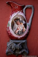 Woman with a fan painted on an old ceramic urn the color red, Mazzoni Museum, Maldonado.