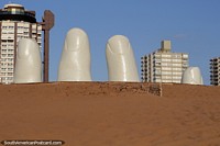 Reaching for the sky, the hand is a big tourist attraction at Brava Beach in Punta del Este. Uruguay, South America.