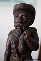 Bearded man with a hat and bottle, wooden sculpture on display at La Vista art gallery, Punta del Este.