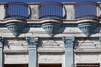 Larger version of Beautiful antique facade painted in creamy blue with rusty patio railing, Rocha.