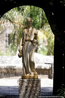 White statue of a woman holding an urn and cup at the atrium at Santa Teresa National Park, Punta del Diablo. Uruguay, South America.