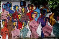 Larger version of Mural featuring colorful female figures at Plaza Independencia in Melo.