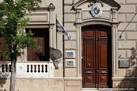 Government building in Tacuarembo with a well-kept stone facade, wooden door and window shutters. Uruguay, South America.