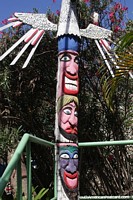 Wooden pole with faces carved and painted in El Yaque, Margarita Island.