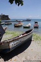 Venezuela Photo - Fishing boats point out to sea behind the wharf in Pampatar.