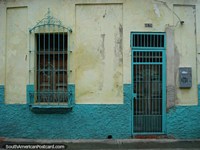 Teal and cream colored house front in Puerto Cabello with lots of character.