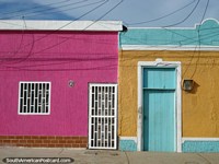 A house of bright pink on a colorful street in Boca de Rio, Isla Margarita. Venezuela, South America.