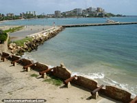 Larger version of View from Castillo San Carlos de Borromeo of the cannon, city, beach, wharf and sea in Pampatar, Isla Margarita.