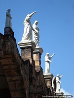 White religious figures stand on the roof of the church at Santa Elena. Venezuela, South America.