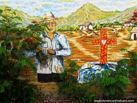 Larger version of Mural of a man and village with big red and yellow cross, El Tintorero.