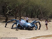 Kids play on a giant spider monument at a park in Coro. Venezuela, South America.