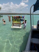 Larger version of A man sells jewelry from a floating polystyrene board at Cajo Los Juanes, Morrocoy National Park.