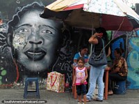 Girls face graffiti art beside the telephone lady of Acarigua. Venezuela, South America.