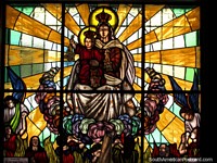 An intricate religious stained glass window at St. Benedict Chapel in Timotes.