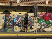 An abstract graffiti mural of 3 characters in Maracaibo.