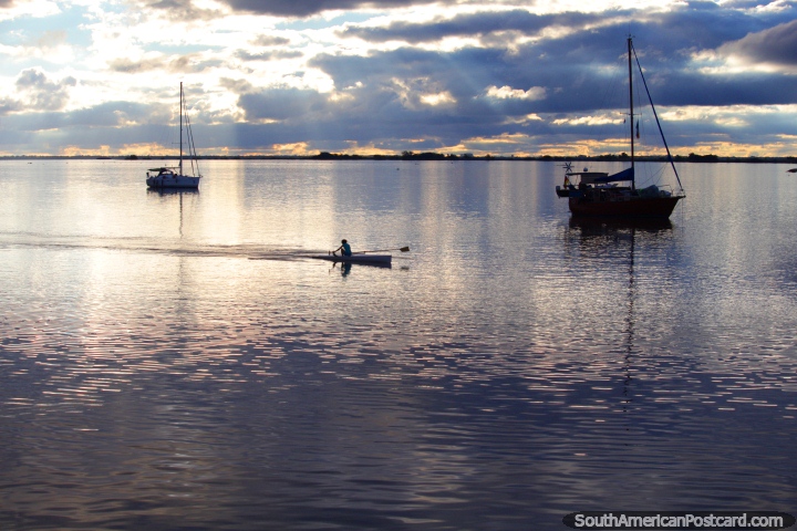 Rowers practice on the Uruguay River in Fray Bentos. (720x480px). Uruguay, South America.