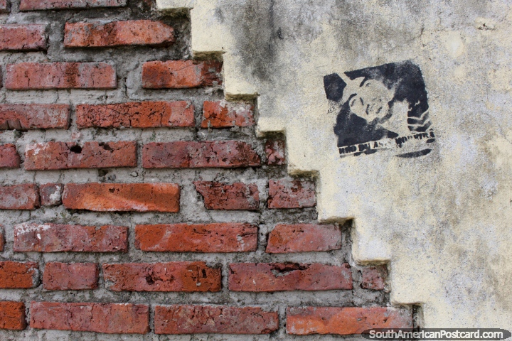 Stencil art of a man beside a brick wall around the waterfront in Fray Bentos. (720x480px). Uruguay, South America.