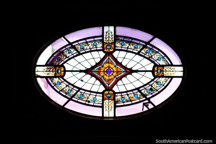 Purple oval-shaped stained glass window on the roof of the fine arts museum in Salto, looks it has peacock feathers. (720x480px). Uruguay, South America.