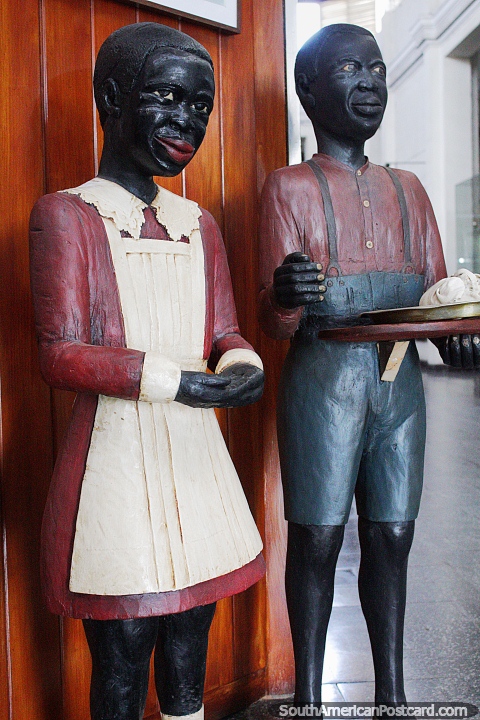 In 1808 African slaves were brought by ship, 2 wooden figures at the museum of man and technology in Salto. (480x720px). Uruguay, South America.