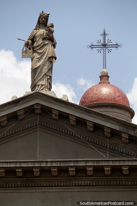 The cupola (dome), cross and statue at the top of the cathedral in Mercedes. (480x720px). Uruguay, South America.