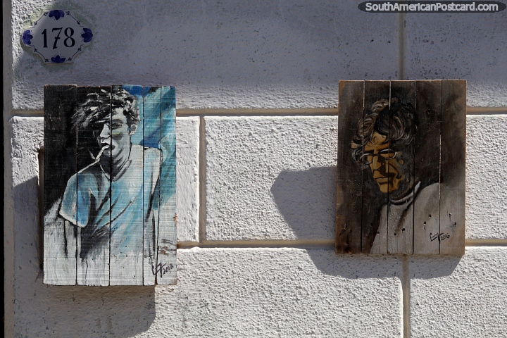 Boy on a street corner and man with glasses, paintings on wood in Colonia. (720x480px). Uruguay, South America.