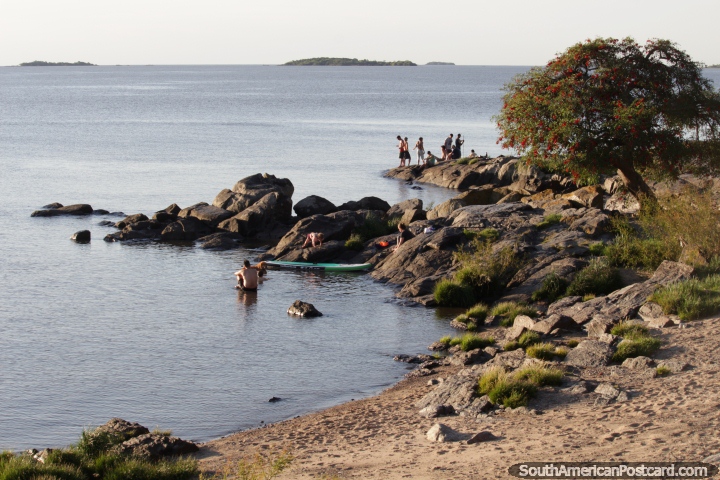 View of the river and people on the rocks in the afternoon around Santa Rita Bastion in Colonia. (720x480px). Uruguay, South America.