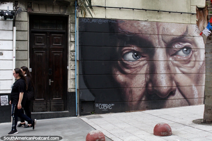 Mans face with pointy eyebrows, a large street mural in central Montevideo. (720x480px). Uruguay, South America.