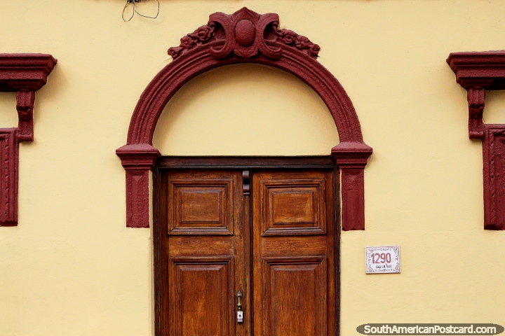 Fachada decorativa y arqueada con una puerta de madera, una bonita entrada en Montevideo. (720x480px). Uruguay, Sudamerica.