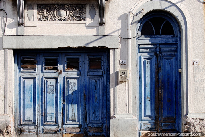 Tall arched wooden door and garage, a mix of old and new in Montevideo. (720x480px). Uruguay, South America.
