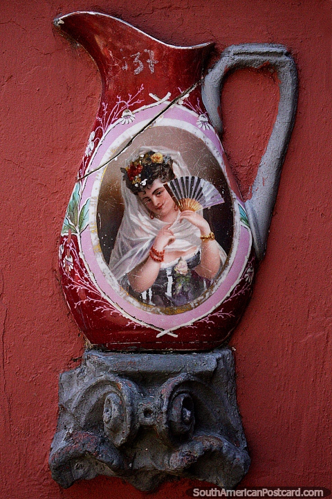 Woman with a fan painted on an old ceramic urn the color red, Mazzoni Museum, Maldonado. (480x720px). Uruguay, South America.