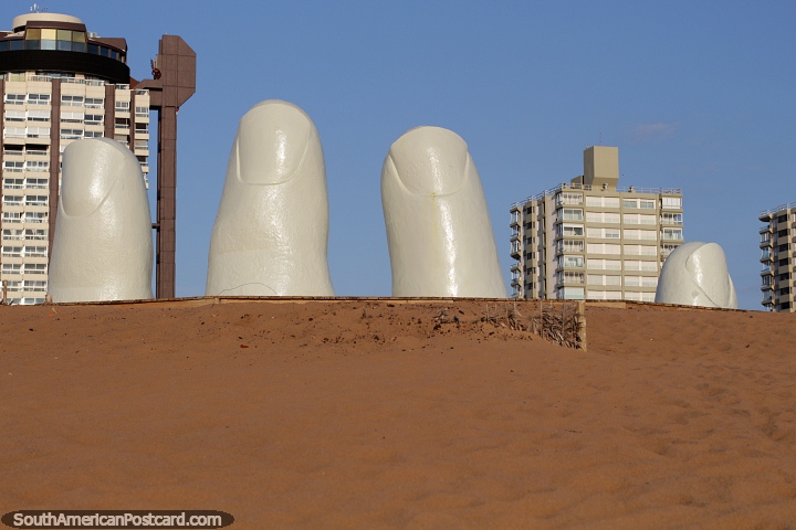 Reaching for the sky, the hand is a big tourist attraction at Brava Beach in Punta del Este. (720x480px). Uruguay, South America.