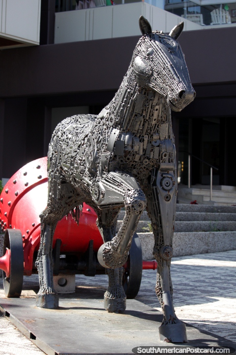 Horse made from nuts and bolts tows a red concrete mixer, La Vista art gallery in Punta del Este. (480x720px). Uruguay, South America.