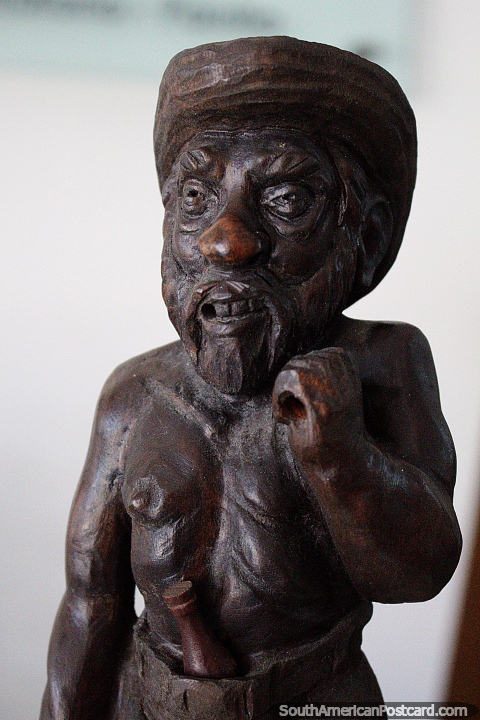 Bearded man with a hat and bottle, wooden sculpture on display at La Vista art gallery, Punta del Este. (480x720px). Uruguay, South America.