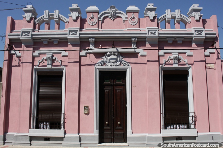 Pink building looks like a castle, beautiful antique facade in fine condition in Rocha. (720x480px). Uruguay, South America.