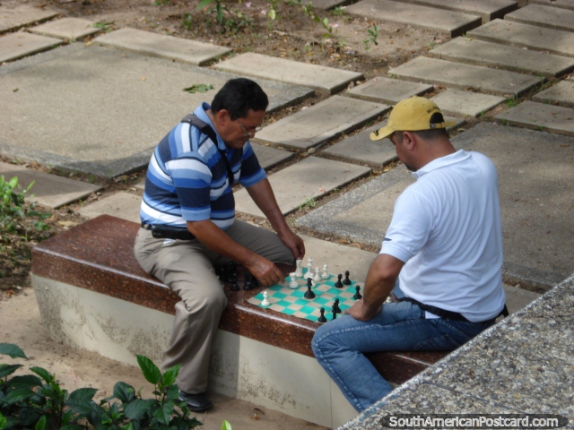 2 men play chess in Plaza Simon Bolivar in San Cristobal. (640x480px). Venezuela, South America.